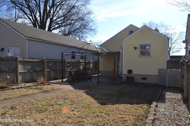 rear view of house featuring a yard, a gazebo, and a patio