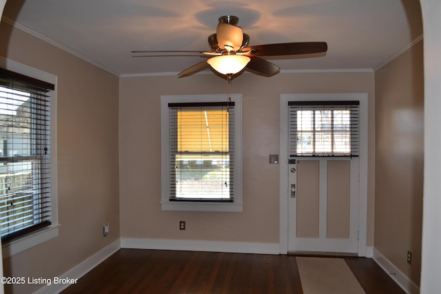 entryway featuring crown molding, dark wood-type flooring, and ceiling fan