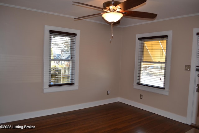 spare room featuring dark hardwood / wood-style flooring, ornamental molding, and ceiling fan