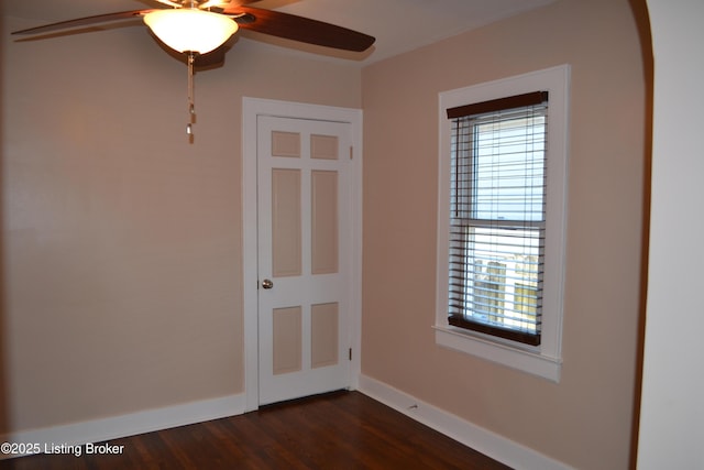 unfurnished room featuring dark hardwood / wood-style flooring and ceiling fan