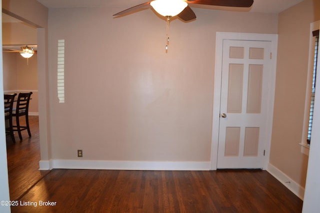 empty room featuring dark hardwood / wood-style flooring and ceiling fan