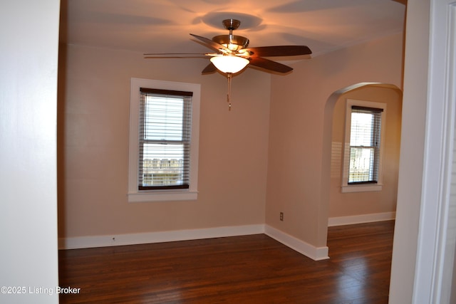 unfurnished room with ceiling fan and dark hardwood / wood-style flooring