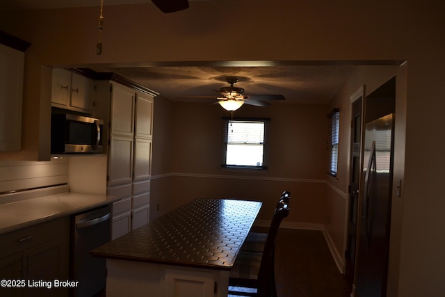 kitchen with ceiling fan, a center island, and dishwasher