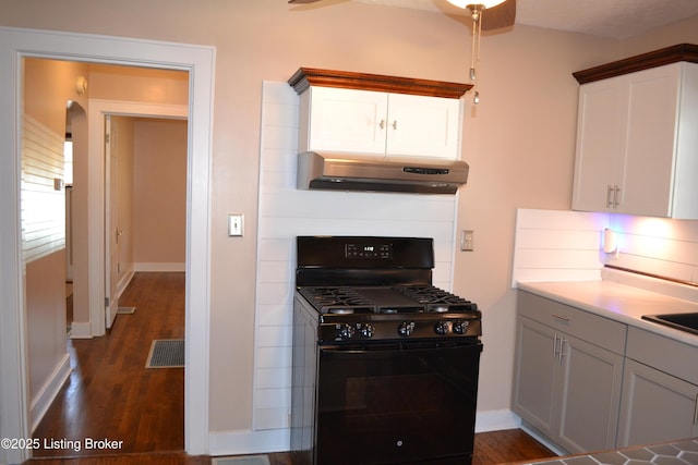 kitchen featuring black range with gas cooktop, dark hardwood / wood-style flooring, and white cabinets