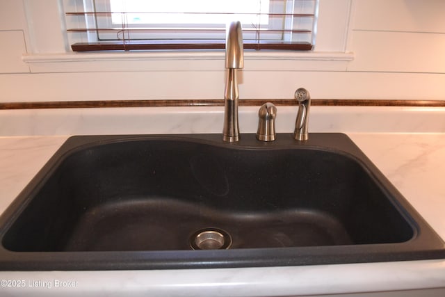 interior details with sink and white cabinets