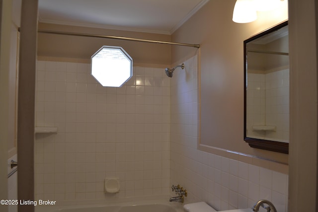 bathroom with tiled shower / bath combo and ornamental molding