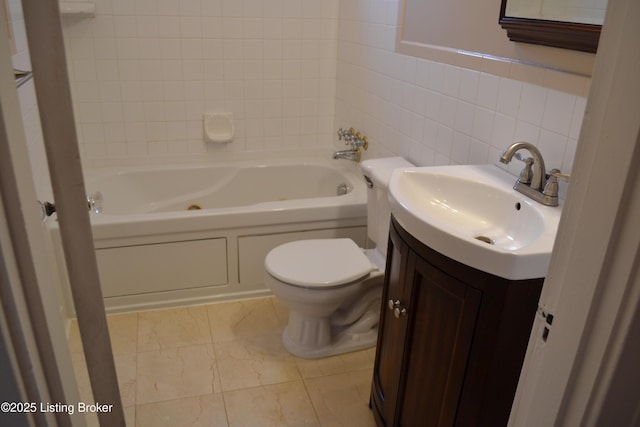 bathroom featuring vanity, toilet, and tile walls