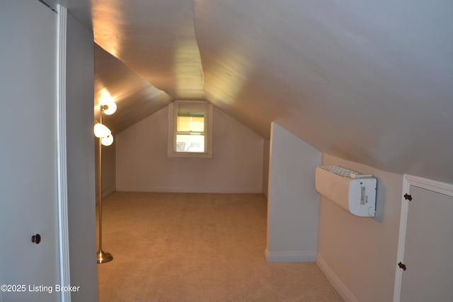 bonus room with vaulted ceiling and light carpet