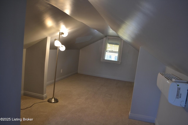 additional living space featuring lofted ceiling and light colored carpet