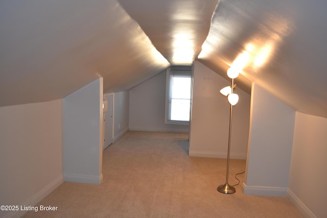 bonus room featuring lofted ceiling and light colored carpet