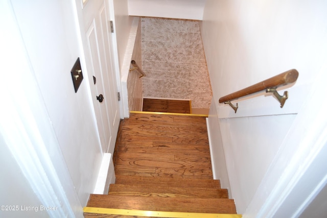 stairs featuring wood-type flooring