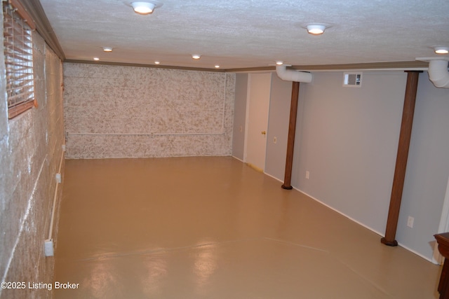 basement featuring a textured ceiling