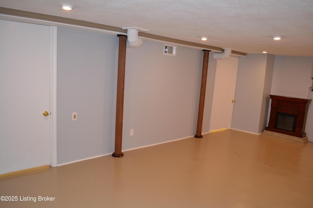 basement featuring a textured ceiling