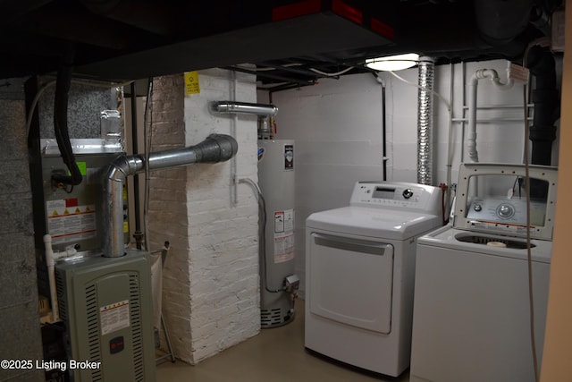 washroom with heating unit, washer and clothes dryer, and water heater