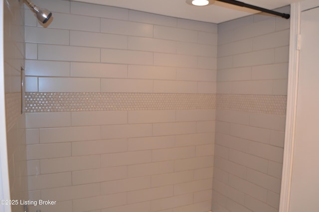 interior details with a tile shower