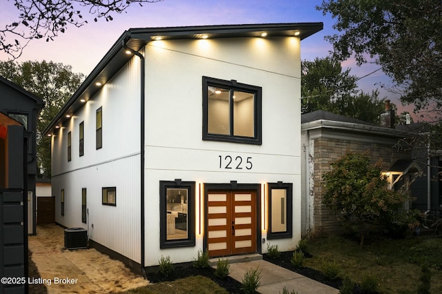 contemporary home featuring central AC and a garage