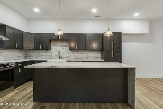 kitchen featuring decorative light fixtures, stainless steel electric stove, and light stone countertops