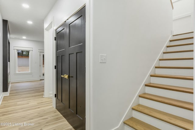 staircase with wood-type flooring