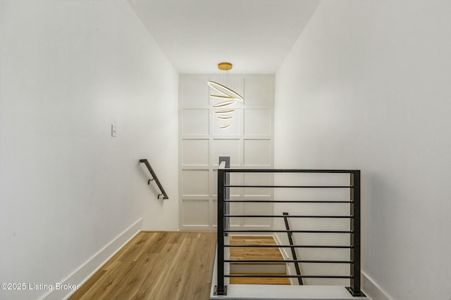 stairs featuring hardwood / wood-style floors