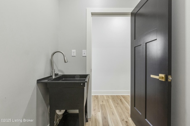 laundry room featuring light wood-type flooring