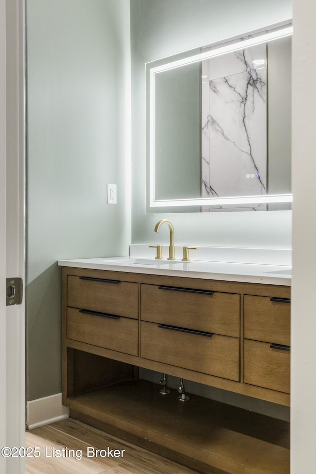 bathroom featuring hardwood / wood-style flooring and vanity