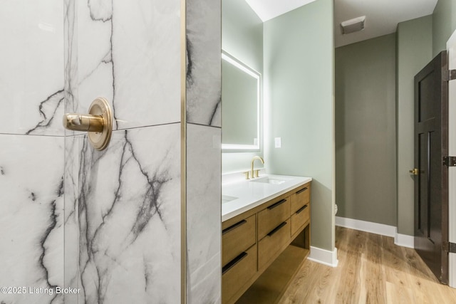 bathroom with vanity, hardwood / wood-style floors, and toilet