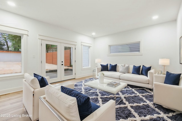 living room with light hardwood / wood-style flooring and french doors