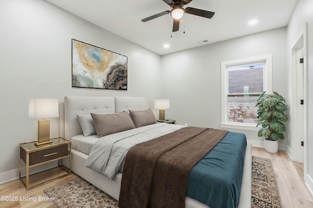 bedroom with light hardwood / wood-style flooring and ceiling fan