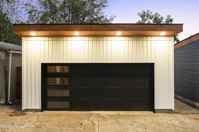 view of garage at dusk