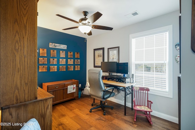 office space featuring ceiling fan and dark hardwood / wood-style flooring