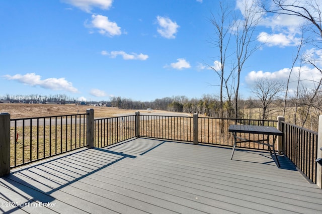 wooden deck with a rural view