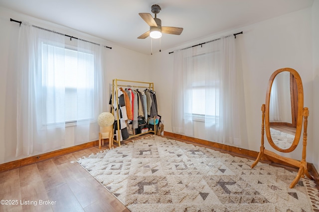 exercise room featuring wood-type flooring, plenty of natural light, and ceiling fan