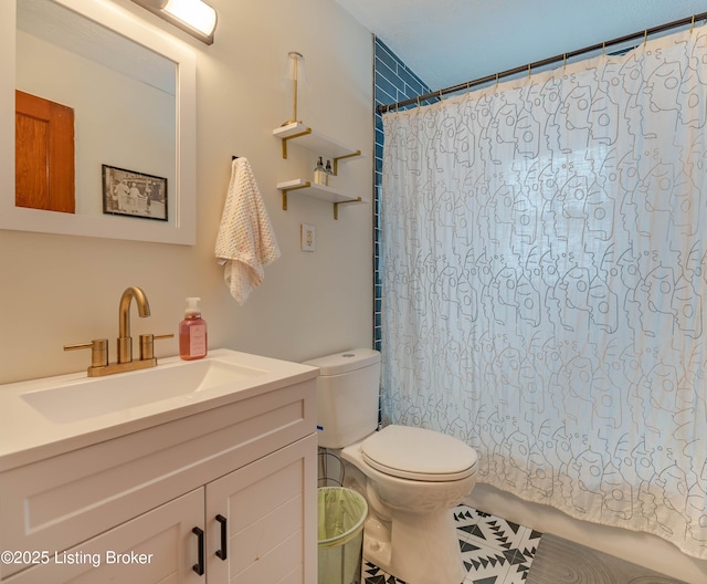 bathroom featuring vanity, curtained shower, and toilet