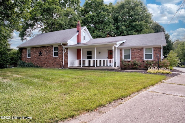 view of front of house with covered porch and a front yard