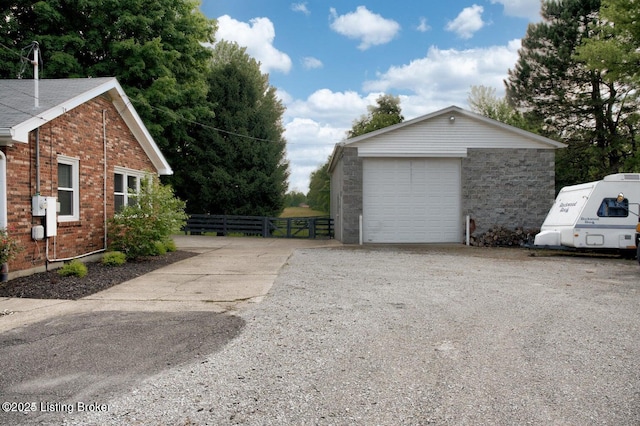 view of side of property featuring an outbuilding and a garage