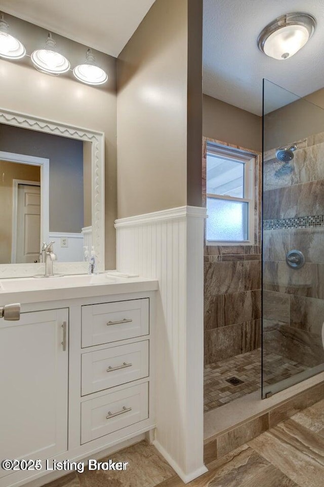 bathroom featuring vanity and a tile shower