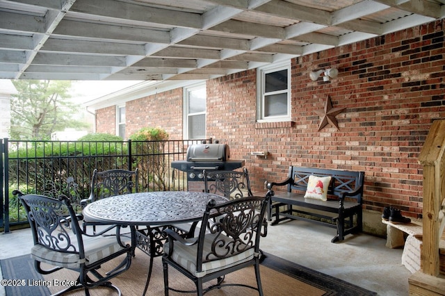 view of patio with grilling area and a pergola