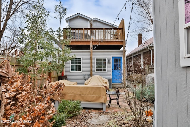 rear view of house with an outdoor hangout area, a patio, and a balcony