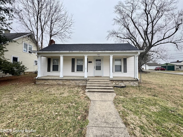 bungalow-style home featuring a front lawn and covered porch