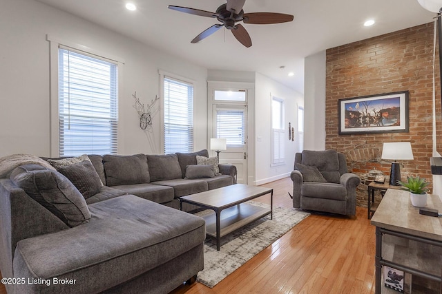 living room featuring light hardwood / wood-style floors and ceiling fan