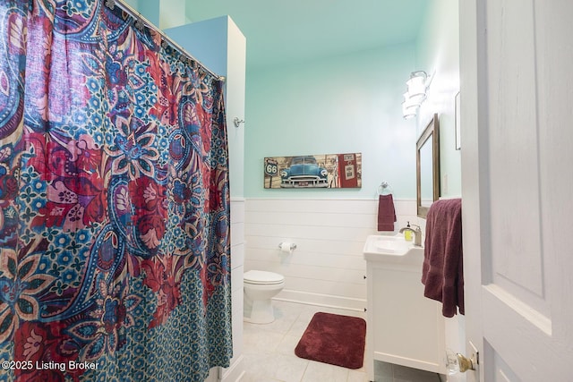 bathroom featuring tile patterned flooring, vanity, and toilet