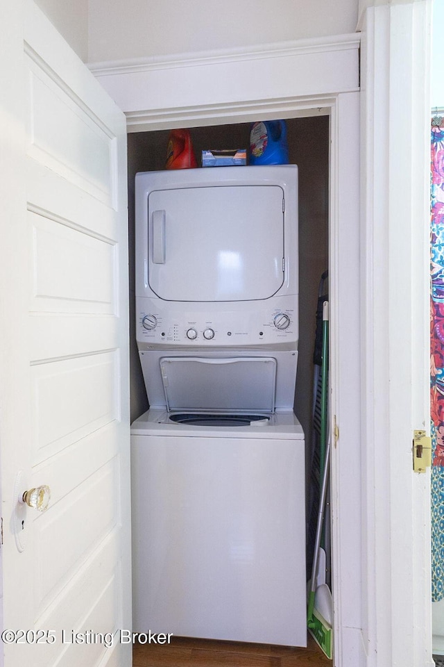 clothes washing area with stacked washer and dryer