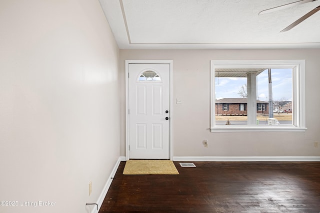 foyer featuring dark wood-type flooring and ceiling fan