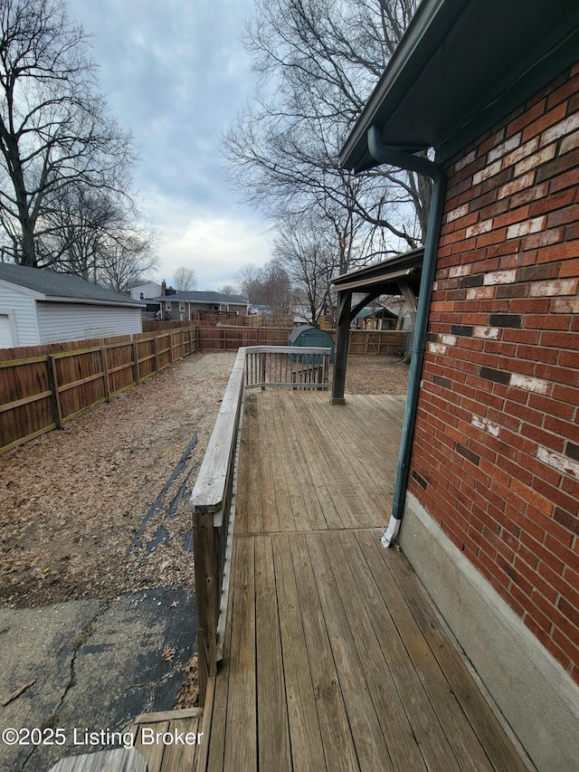 wooden deck featuring a fenced backyard