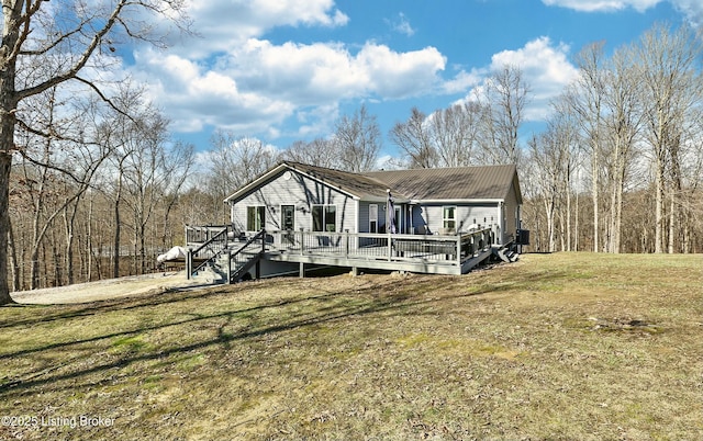 view of front of property with a front lawn and a deck