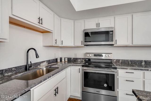 kitchen with white cabinetry, appliances with stainless steel finishes, and sink