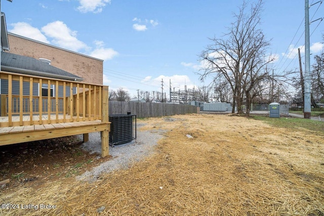 view of yard featuring a wooden deck and central AC unit