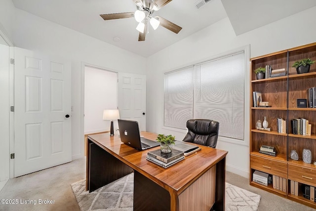 office area featuring a ceiling fan, light colored carpet, visible vents, and baseboards