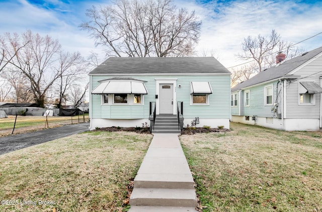 bungalow-style house with a front yard