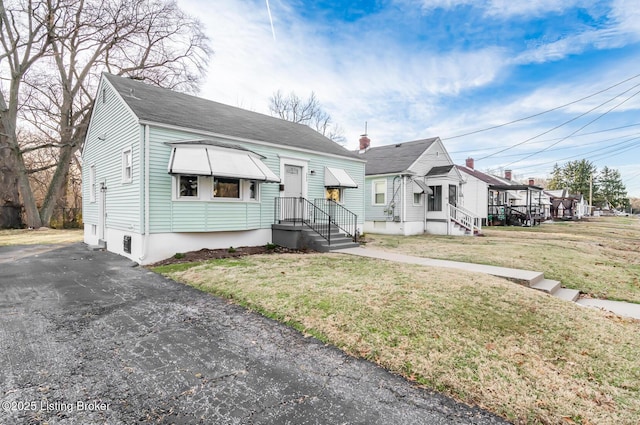 bungalow-style home with a front yard